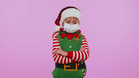 Girl Christmas Santa Claus Elf in Face Mask PPE to Safe From Coronavirus on Lockdown Quarantine