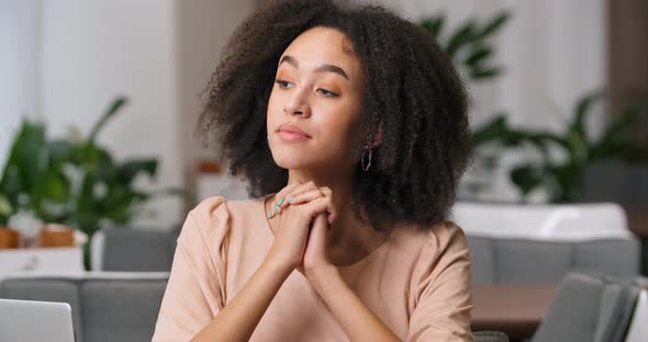 Closeup Front View of Pensive Female Face Portrait of Afro American Curly Millennial Visitor Lady