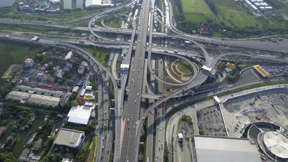 Aerial View of Highway Road Interchange with Busy Urban Traffic Speeding on Road