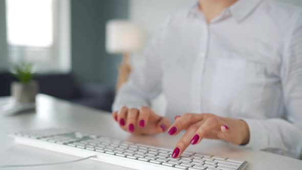 Woman Typing on a Computer Keyboard