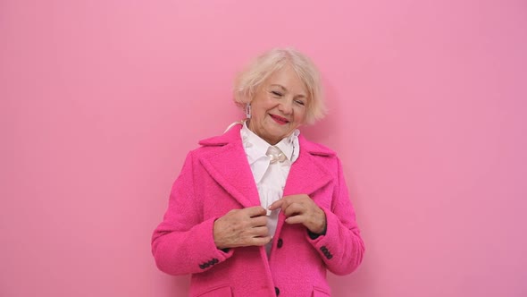 Happy, Positive Pensioner Having Fun at a Photo Shoot, Flirting on Camera in the Studio