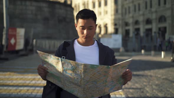Real Time Shot of a Young Asian Man Looking at a Map. Tourist in Moscow. Moscow Is the Capital and