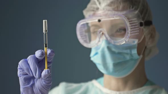 Portrait of a Young Nurse with a Syringe Ready to Vaccinate a Patient Against Covid 19