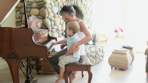 Grandmother and grandson playing piano