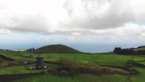 Coastal road by Atlantic Ocean . Green rural farmland. Sao Miguel Islands, Azores.