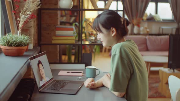 Asian Woman Chatting on Video Call at Home