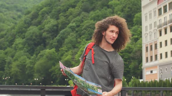 Young Beautiful Tourist with Route Maps Looking for a Road.