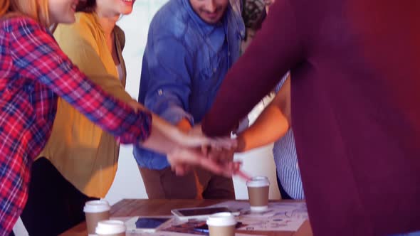 Business colleagues forming hand stack