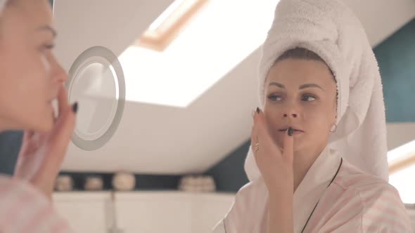 Attractive Woman Applying Cream on Skin Under Eyes at Home