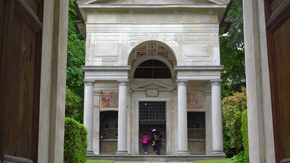 A mother and her little daughter carrying a teddy bear visiting the sacred mountain of Varallo chris