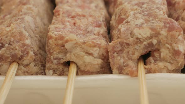 Close-up View Of Uncook Mititei On Skewers - Romanian Cuisine. - slider