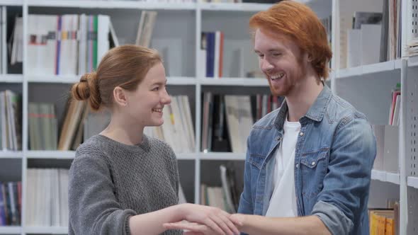 Happy Man and Woman Doing Promise Gesture in Office