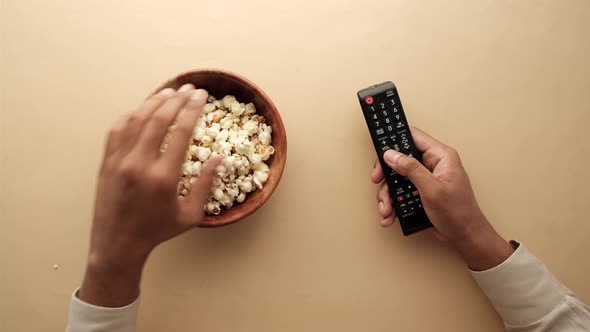 High Angle View of Popcorn and Tv Remote on Table