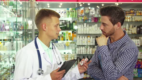 Doctor Exploring Pills Instruction To Patient