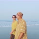 Senior couple walking on the beach and talking, steadicam shot - VideoHive Item for Sale