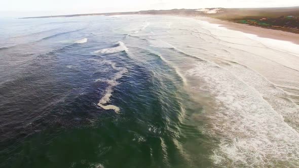 Aerial view of waves reaching a shore at beach