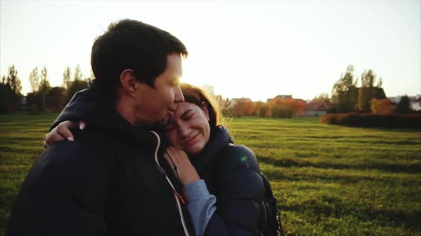 Young Man Kiss Woman and Making Selfie Outdoor Strong Back Light Slow Motion