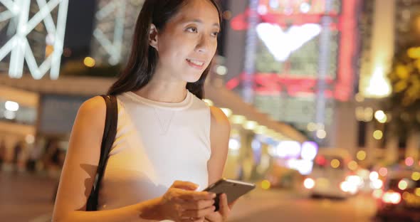 Woman using cellphone at night 