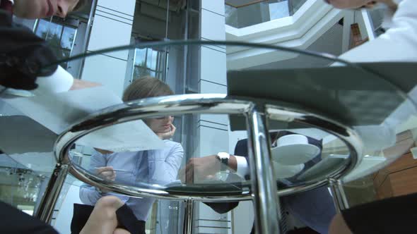 Business Team Working at Glass Table in Modern Office Center