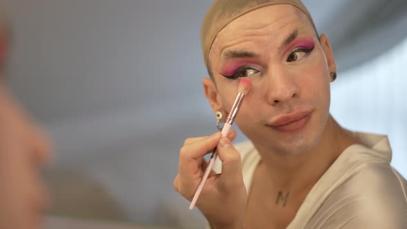 Closeup Reflection in Mirror of Confident Transgender Caucasian Young Woman in Wig Cap Applying