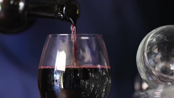 Wine. Closeup Of Red Wine Pouring Into Glass From Bottle