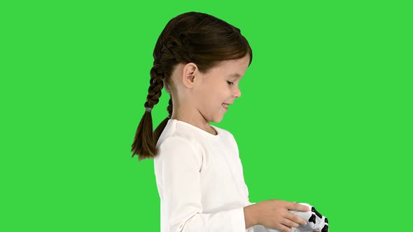 Smiling Little Girl Play Videogame Holding Joystick in Her Hands on a Green Screen, Chroma Key.