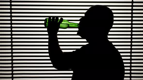 Man Drinking Beer on White Striped Background