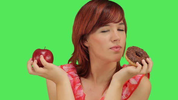 Woman deciding between Doughnut and Apple