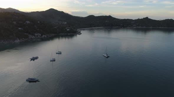 Flight To Sunset over Sea with Boats