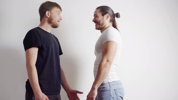 Men Actors are Talking to Each Other Laughing Getting Ready for a Shoot on a White Background