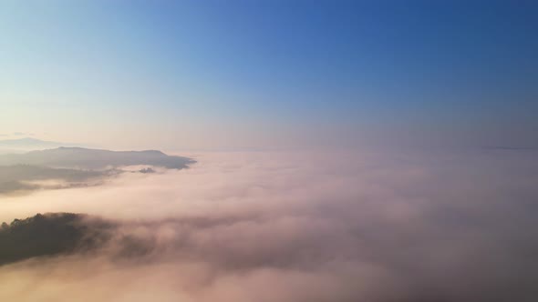 4K Aerial video Beautiful sunrise above dense clouds and fog in the morning