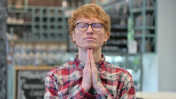 Hopeful Young Redhead Man Praying