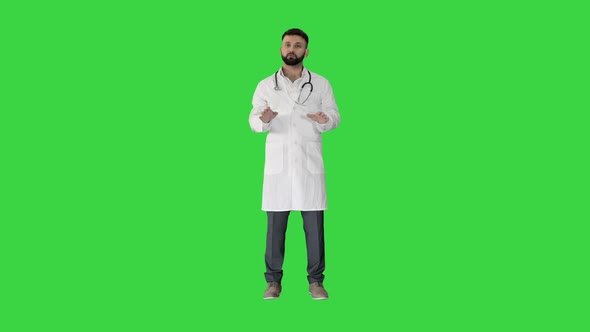 Confident Doctor Talking and Looking Into the Camera on a Green Screen, Chroma Key.