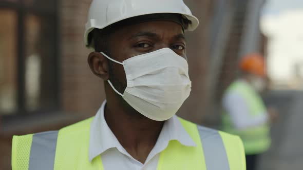 African American Constructor in Face Mask Posing Outdoors