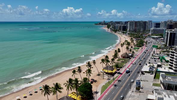 Aerial panning shot of turquoise water beach at Maceio Alagoas Brazil. 