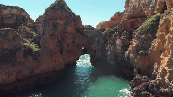 Natural rocky archways in rugged Lagos Shoreline, in Algarve, Portugal