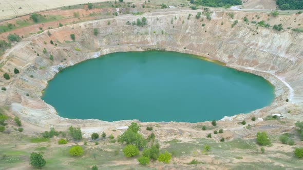 Abandoned Copper Open Pit Quarry Filled With Blue Water, Drone View