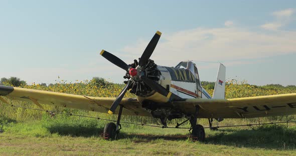 Old Restored Airplane Standing on the Ground with Propeller Wings and Wheels