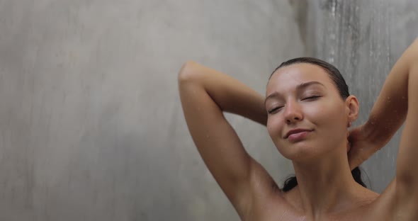 Spa Woman Under Running Water in Hot Shower