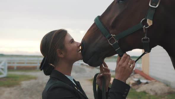 Horse Owner Kissing Her Seal Brown Horse With Love Holding The Rope Of Her Horse