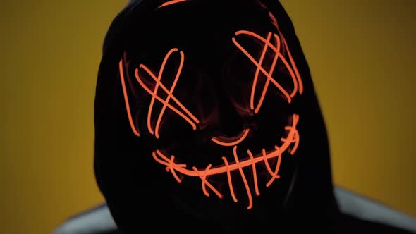 Anonymous in Mask with Orange Led Neon