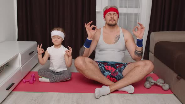 Kid Daughter and Young Father in Retro Style Clothing Doing Yoga Meditation Exercises Together