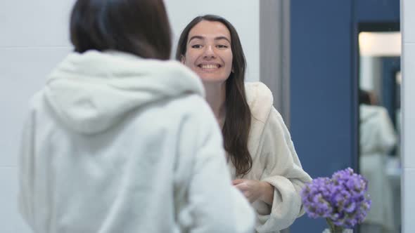 Middle-aged Woman Checking Face in the Mirror