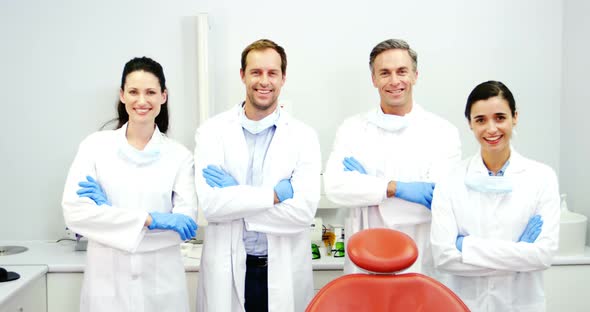 Smiling dentists standing with arms crossed