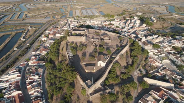 Descending aerial shot with point of interest on the medieval castle in Castro Marim, Portugal