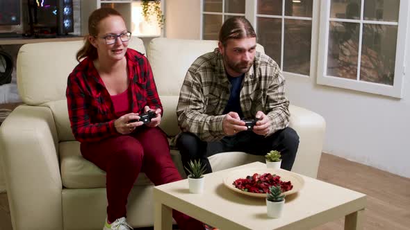 Couple in Their 30's Relaxing Playing Video Games
