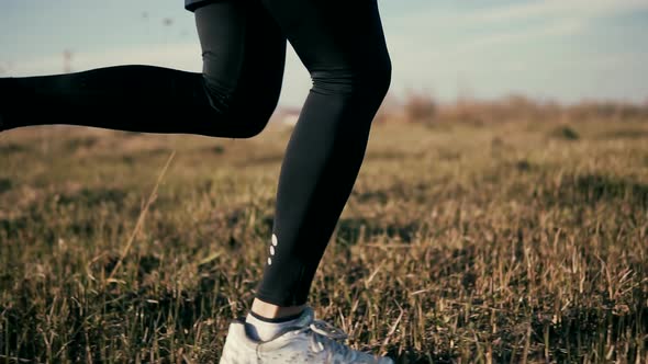 Runner Man Fit Athlete Legs Jogging On Trail Ready To Triathlon. Marathon Runner Jog On Trail.