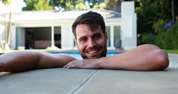 Portrait of young man relaxing in the pool