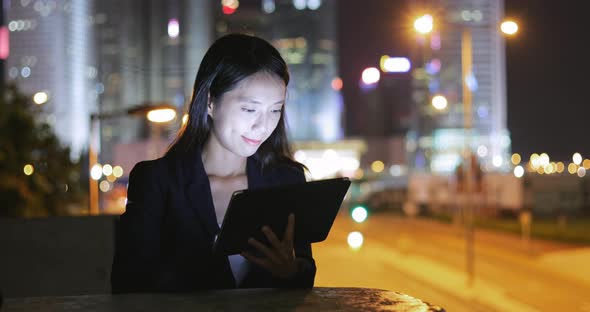 Business woman use of smart phone at night 