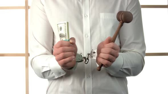 Closeup Portrait of Man Holding Bundle of Money and the Gavel